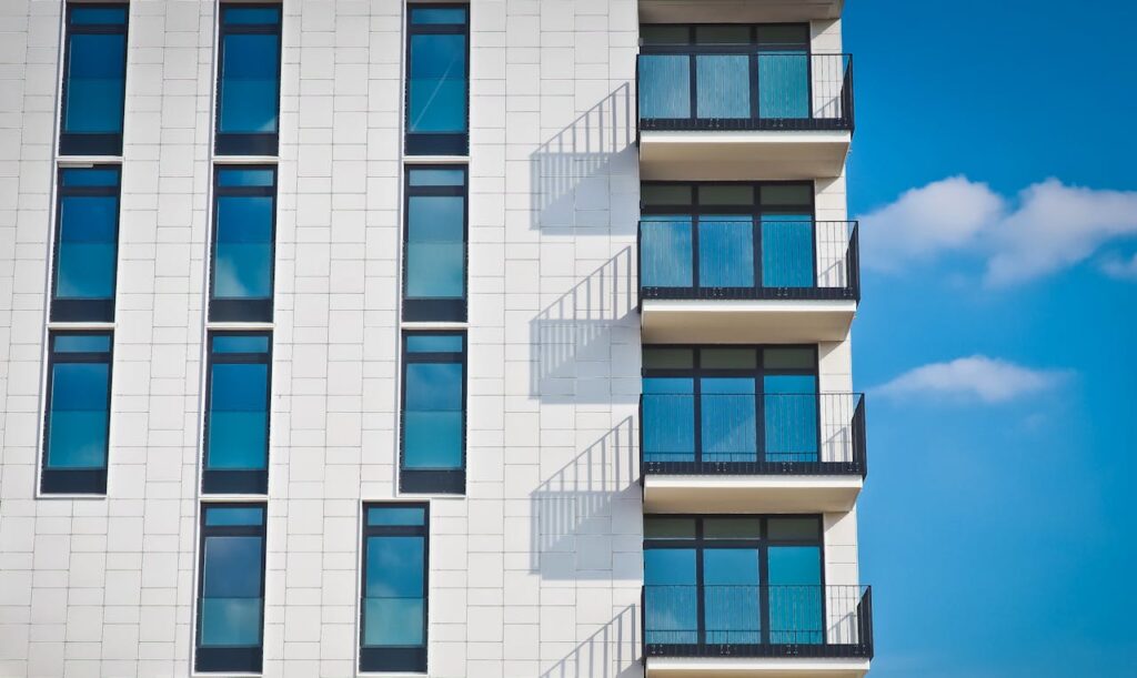 pexels-photo-259950 Contemporary urban apartment building with framed glass windows against clear blue sky.